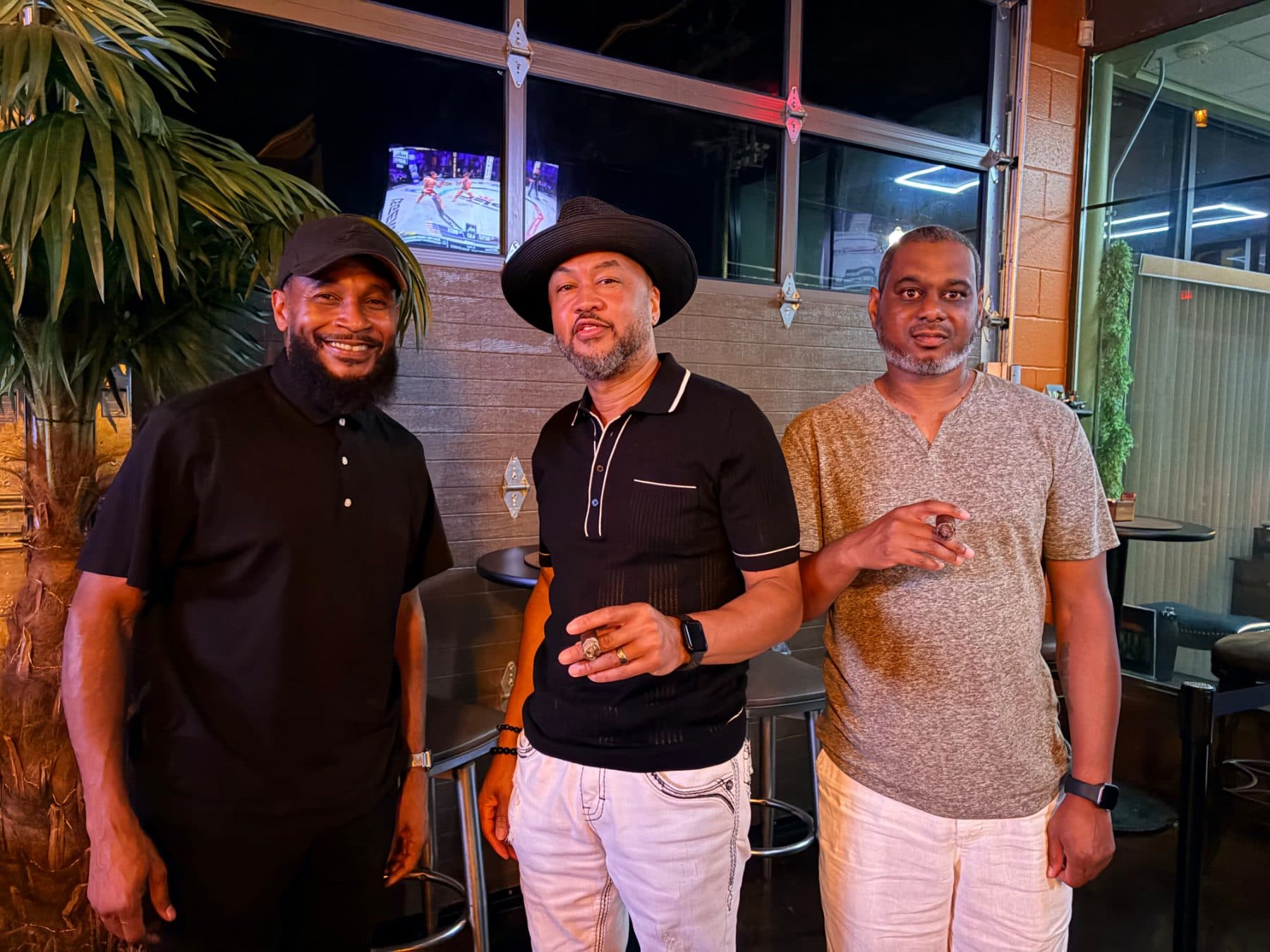 Three guests standing together with cigars at The Bay
